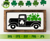 Decorative sign with a black truck and green shamrocks in a wooden frame, suitable for St. Patrick's Day.