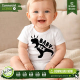 Adorable close-up mockup of a smiling baby wearing a white bodysuit (onesie) with the smaller Baby-Rex T-Rex silhouette design printed on it. The design is black, featuring a dinosaur with three radiant lines above its head. The commercial license and 02 Designs Included details are visible. Gao Designs Store branding included.