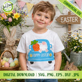 Smiling young boy wearing a white kids t-shirt printed with the front-view vintage blue Easter truck and bunny butt design on the chest; grassy field setting with a basket of Easter eggs and an Easter sign