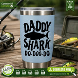 The Daddy Shark Do-Doo-Do digital design displayed on a light blue tumbler, sitting on a wooden dock next to a tackle box and fishing lures. An ideal sublimation mockup for crafting personalized dad gifts tailored to fishing enthusiasts.