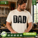 High-quality preview of a man working in a woodshop wearing a cream-colored shirt printed with the Tools Dad silhouette design, showcasing a professional and masculine look for DIY handmade gifts.