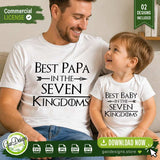 a happy father and toddler sitting on a couch wearing matching white custom apparel with the Best Papa and Best Baby in the Seven Kingdoms designs, perfect for fantasy fan gift ideas.