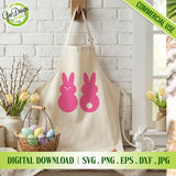 Beige kitchen apron mockup featuring two simple solid pink Easter Peeps bunny silhouettes (one with a face, one with a tail) hanging in a farmhouse kitchen